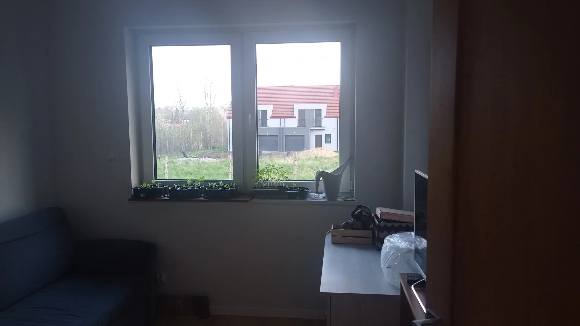 Dodatkowy pokój przed metamorfozą: okno z widokiem na sąsiednie domy